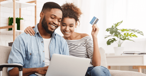 Smiling couple looking at a laptop