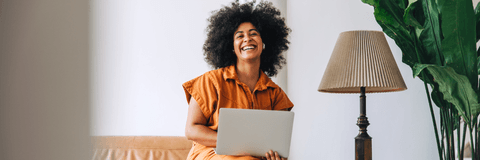 smiling person on laptop