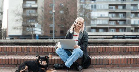 person working outdoors on laptop
