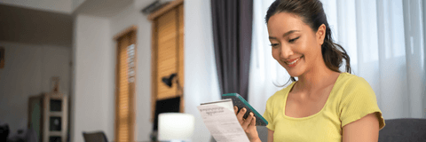 person paying bills on phone