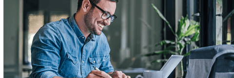 person smiling at laptop