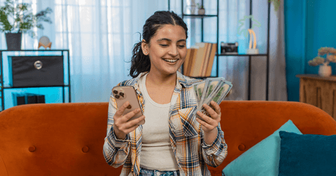Girl with cell phone and cash