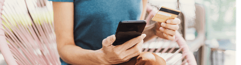 person holding phone and credit card