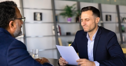 Young boss firing older employee