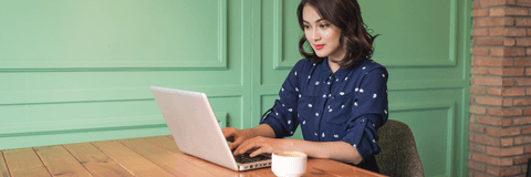 Woman on computer at coffee shop
