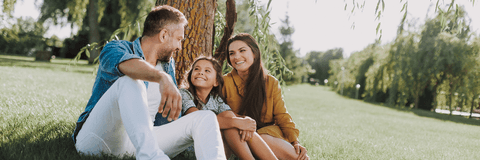 Family sitting under tree