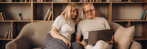 Couple using laptop at home