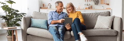 Middle-aged couple sitting on couch