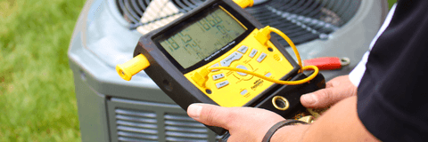 Air conditioning repair man testing unit
