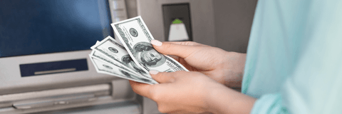 Woman getting money out of atm