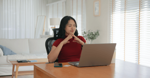 Young woman on computer reading reviews before purchasing