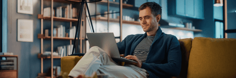 Young man looking at online banking on laptop