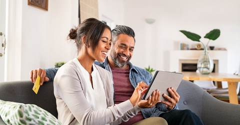 Couple on couch with tablet