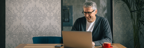 Man on laptop looking at banking options