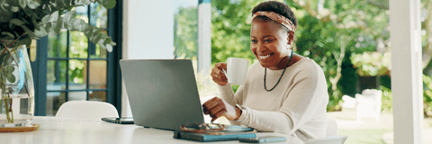 Woman checking her online banking on laptop