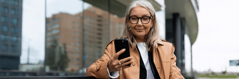 Woman sitting on bench checking online banking