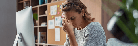 Woman looking at computer stressed out