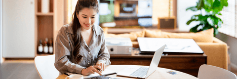 Woman using calculator and computer