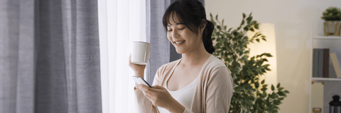 Woman checking savings account interest on phone