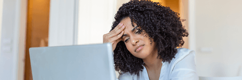 Woman looking confused at computer