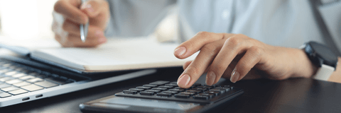 Woman reviewing finances with calculator