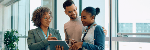 Financial advisor with young couple going over savings account