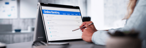 Woman checking online banking on tablet