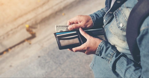 Person pulling money out of wallet