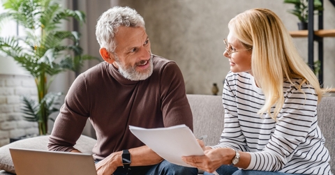 couple at computer looking at paperwork