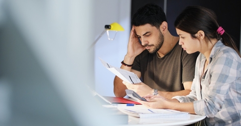 Man and woman looking at bills