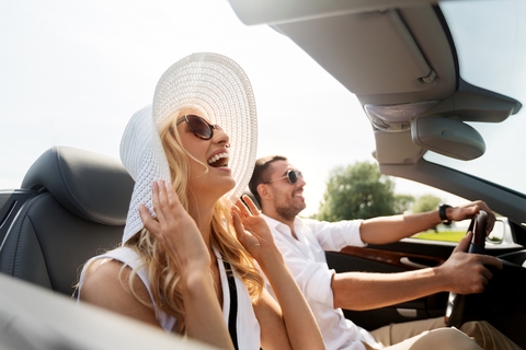 Couple riding in convertible