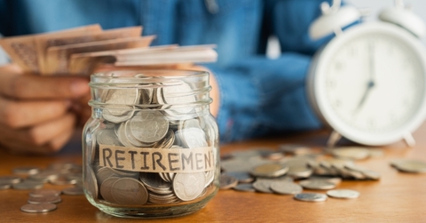 Jar filled with coins labeled retirement 