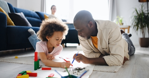Father and child coloring together