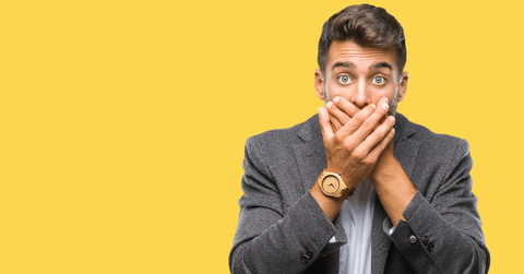 business man covering mouth with hand