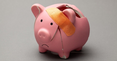 Broken piggy bank with band-aid