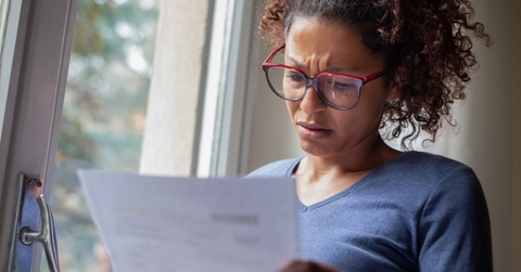 Worried woman looking at bills