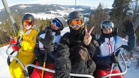 A picture of teenaged skiers on a ski lift