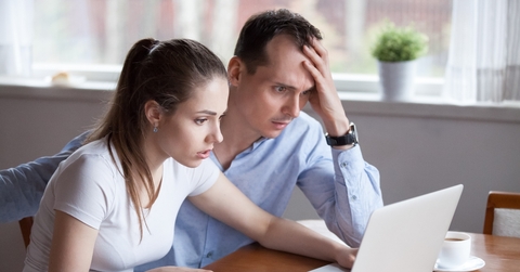 Upset couple looking at computer