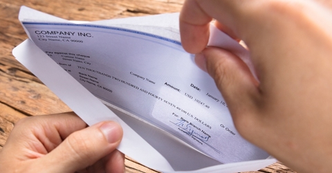 hands checking a paycheck
