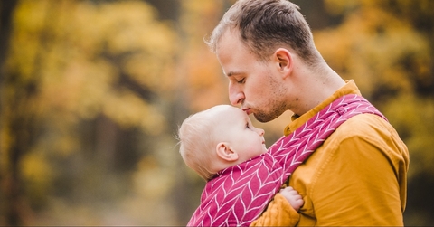 Father and a baby in a baby carrier picture