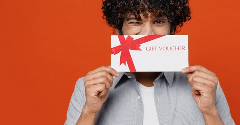 young man holding a gift voucher card