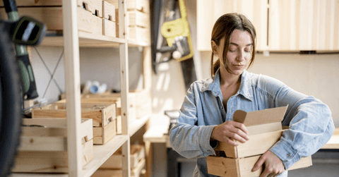 Woman storing boxes in garage