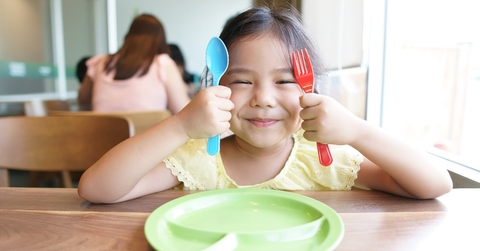  kid girl holding colorful spoon and fork 
