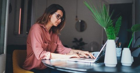 young female entrepreneur working remotely from a home office