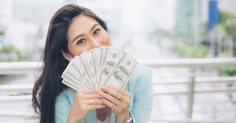asian business woman holding money US dollar bills 
