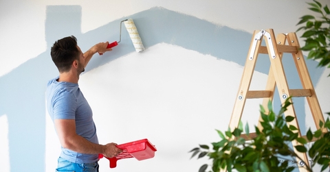 rear view of man while doing some housework