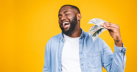 african american man in casual t-shirt holding money dollar bills