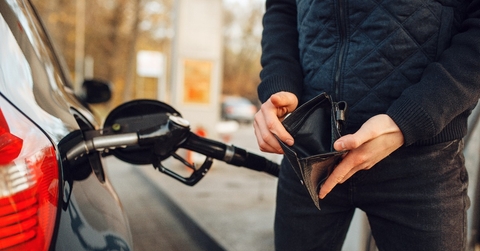 man with empty purse on gas station