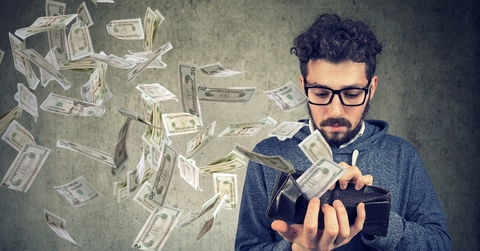 hipster man looking at his wallet with money dollar banknotes flying out away