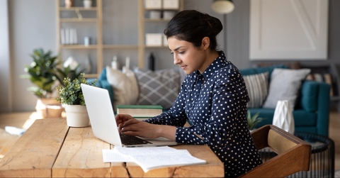 student freelancer sitting at desk in modern cozy home office